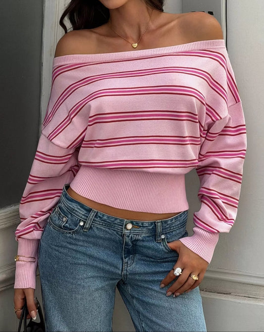 Pink striped off-shoulder cropped top with long sleeves and a wide ribbed hem, styled with blue jeans.