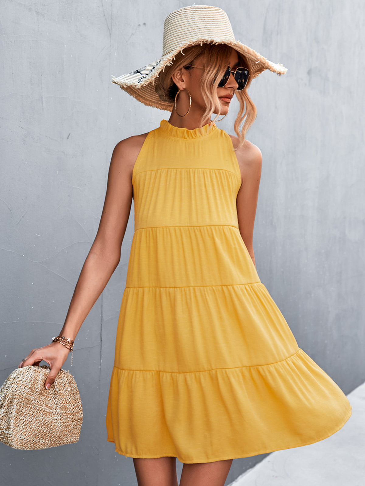 Marigold Collections Australia sleeveless tiered mini dress with high neckline and back tie, styled for casual or summer wear