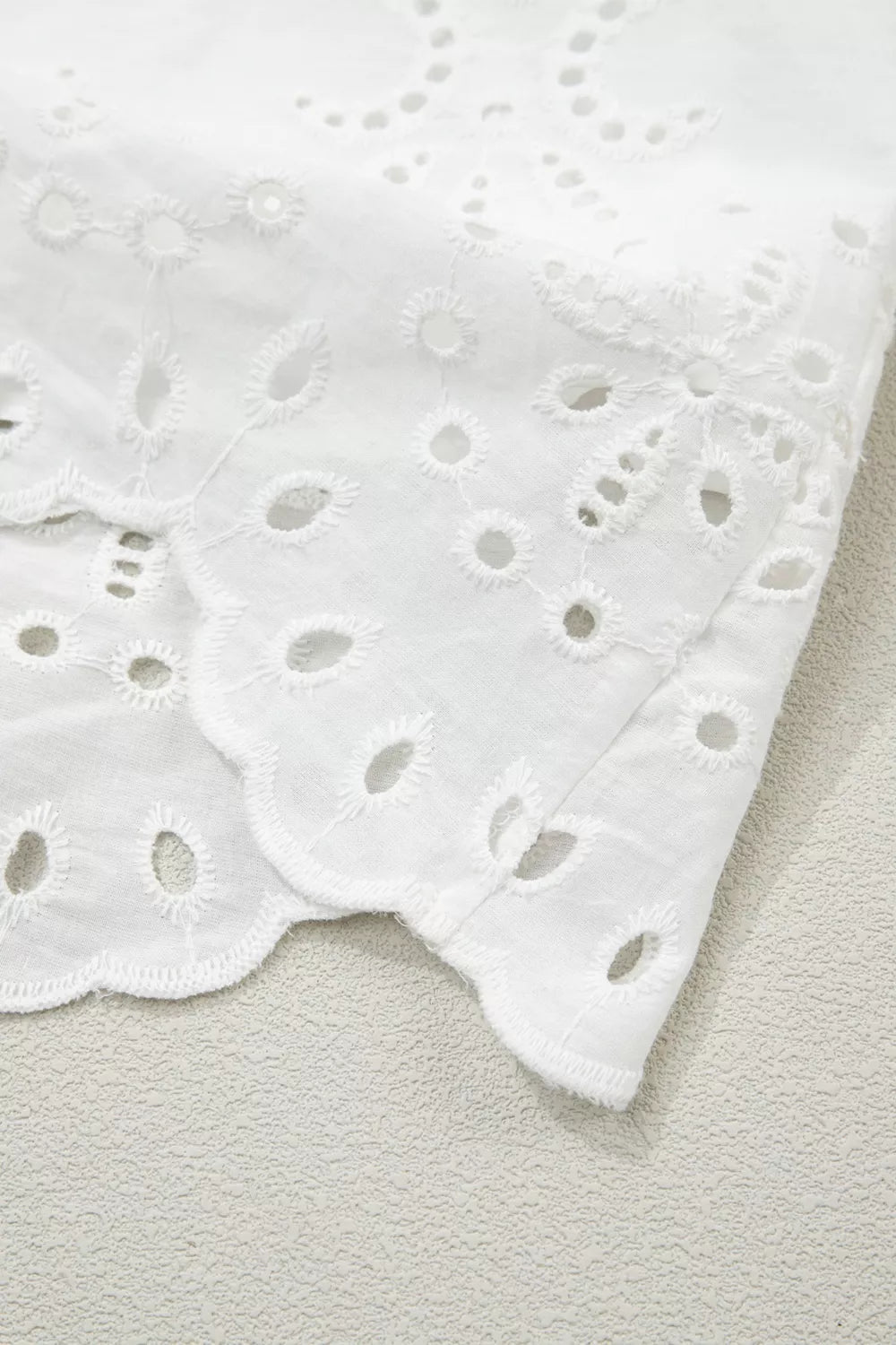 White eyelet collared mini dress by Marigold Collections Australia, featuring a feminine neckline and eyelet detailing.