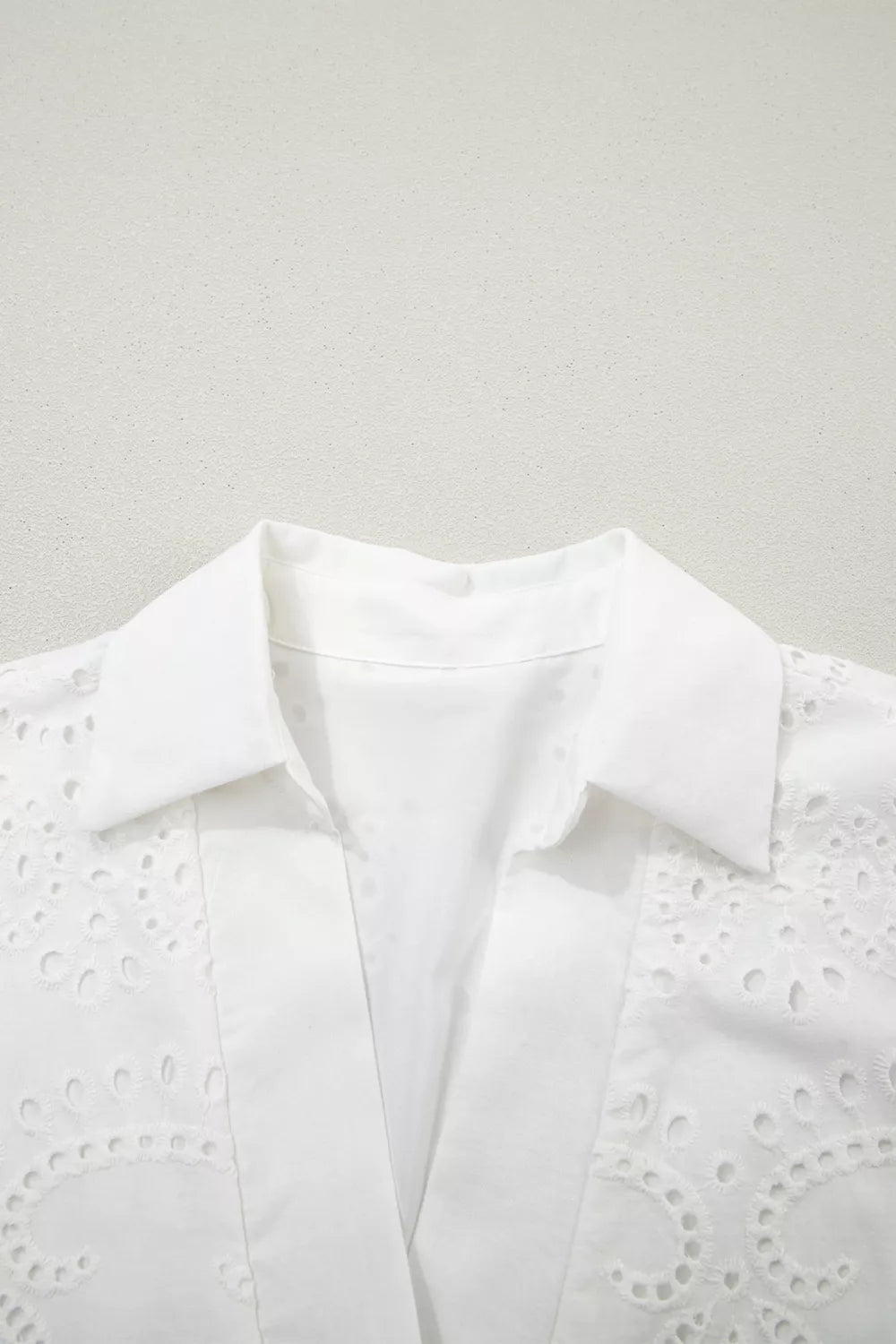 White eyelet collared mini dress by Marigold Collections Australia, featuring a feminine design and eyelet detailing.