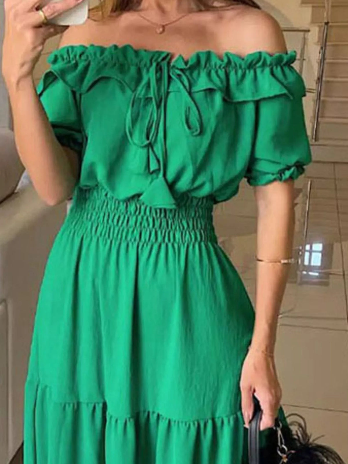 Off-shoulder ruffled tiered maxi dress by Marigold Collections Australia, flowing fabric with layered ruffle details.