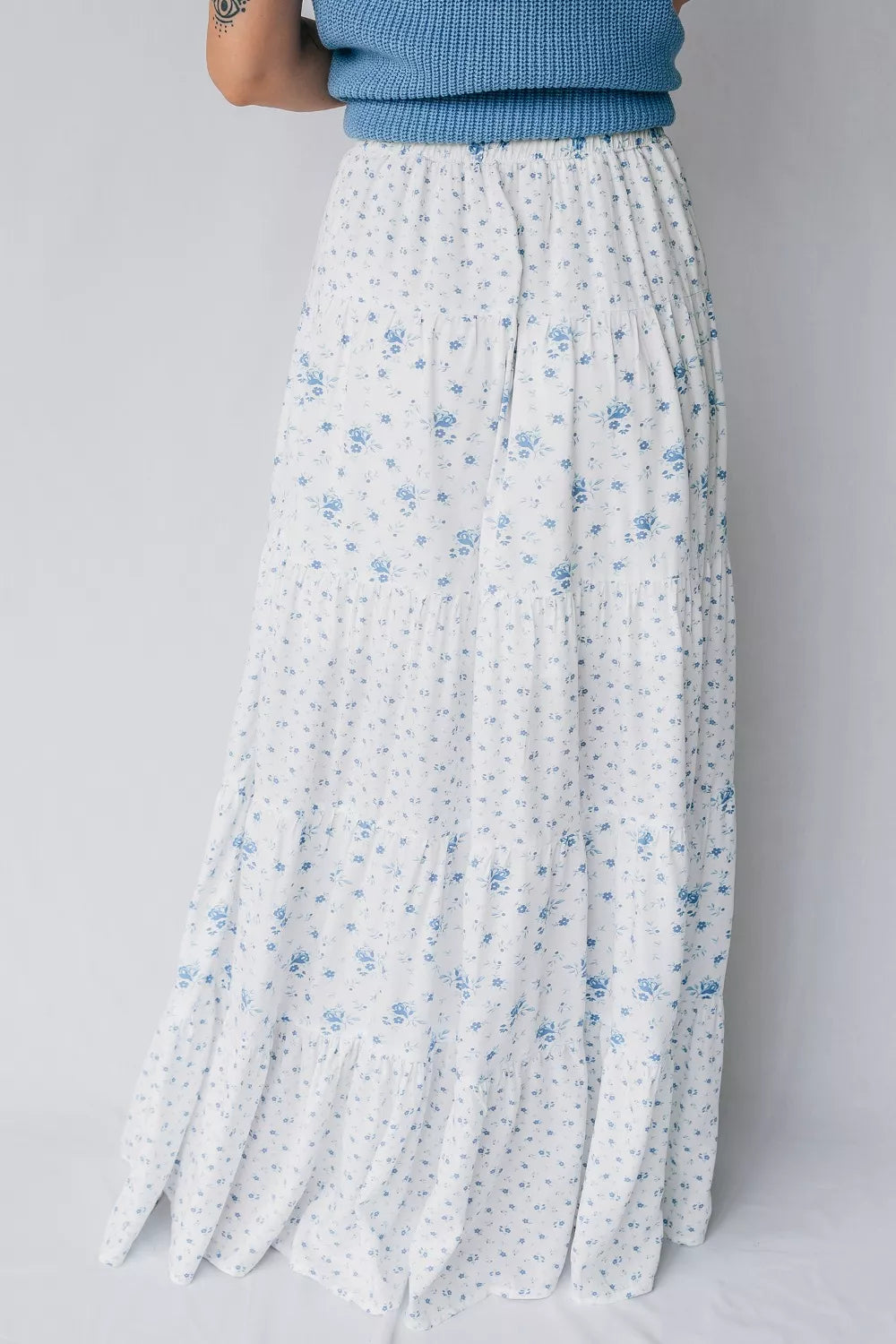 Blue floral tiered maxi skirt from Marigold Collections Australia featuring flowing fabric and a layered design.