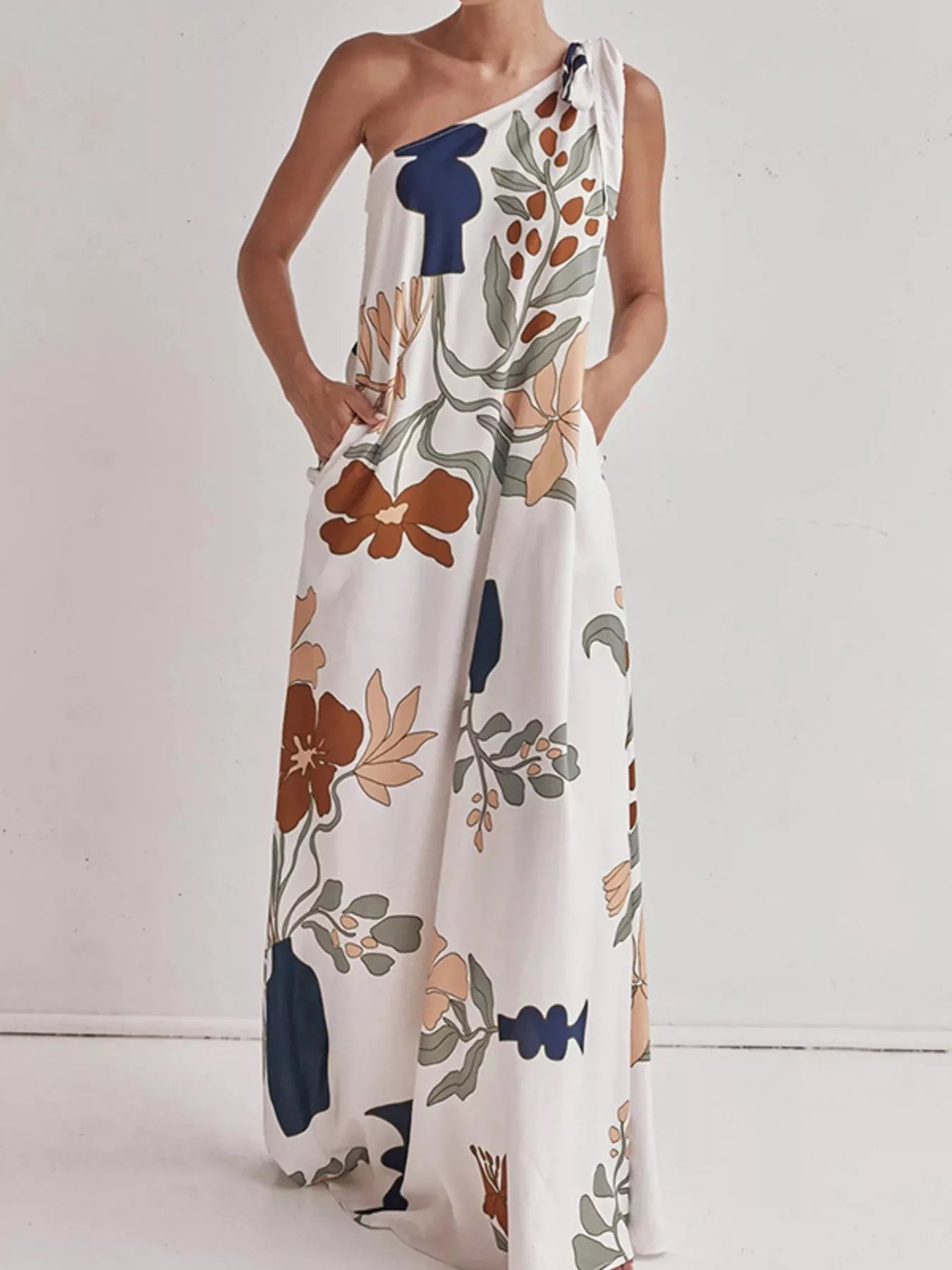 Tall modern floral print one-shoulder maxi dress by Marigold Collections Australia, featuring vibrant flower patterns and elegant design.