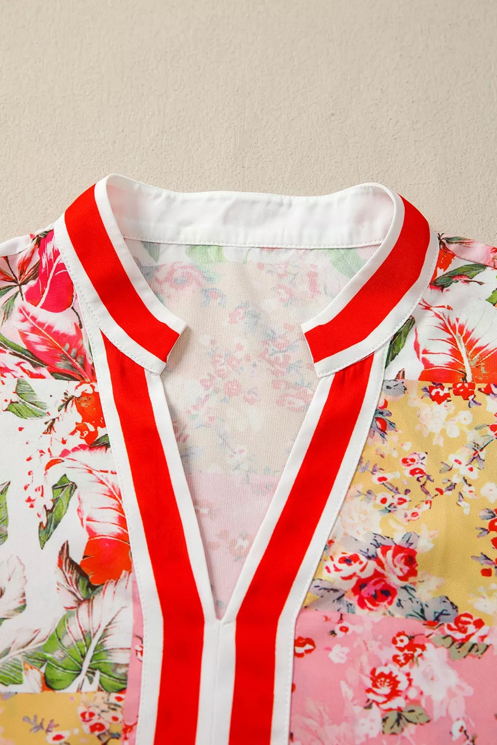 Contrast collared V-neck floral blouse by Marigold Collections Australia, short sleeve top with vibrant flower pattern.