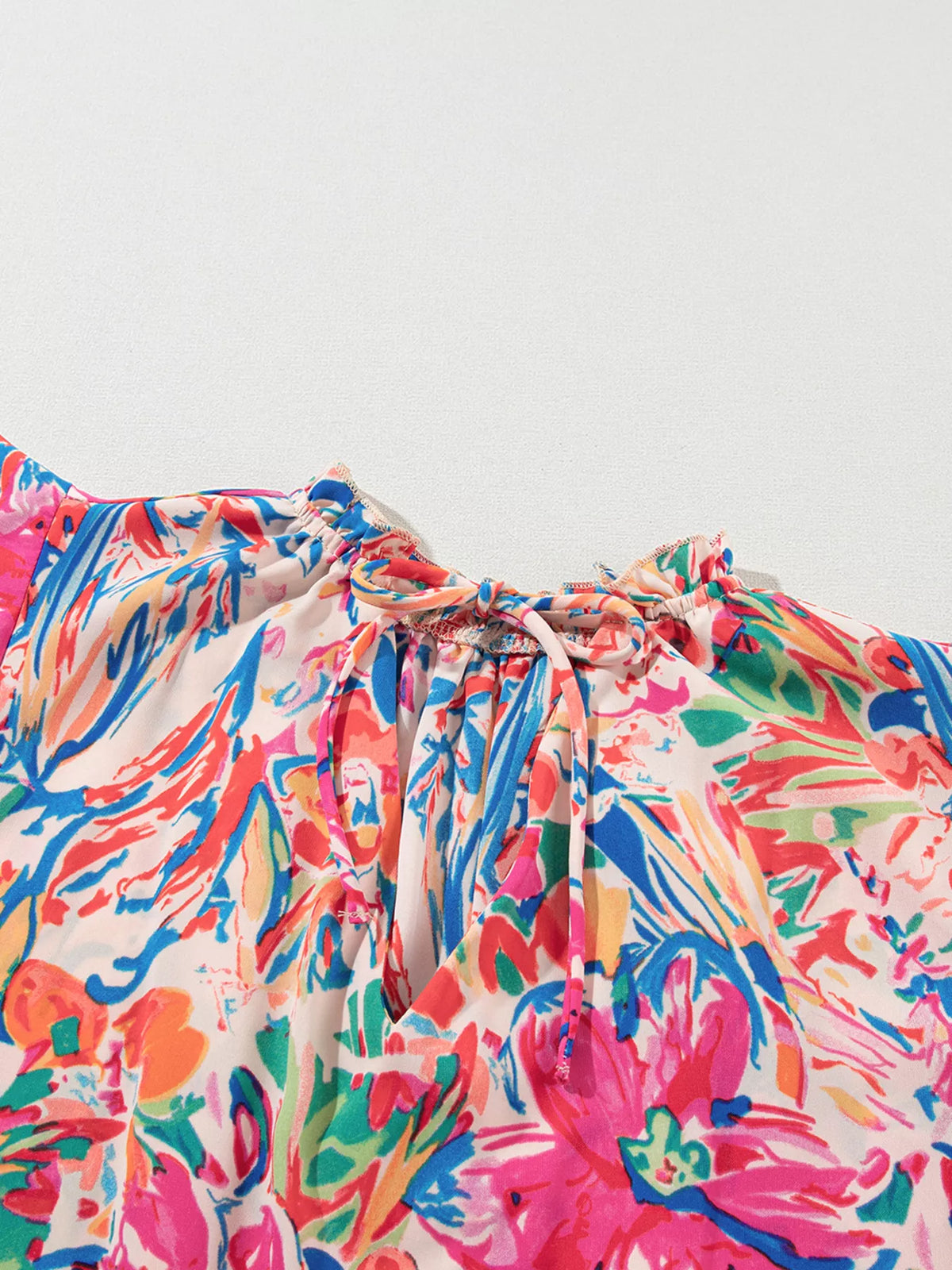 Multicolour floral ruffled sleeve V-neck summer blouse by Marigold Collections Australia, featuring a vibrant floral pattern and feminine design.