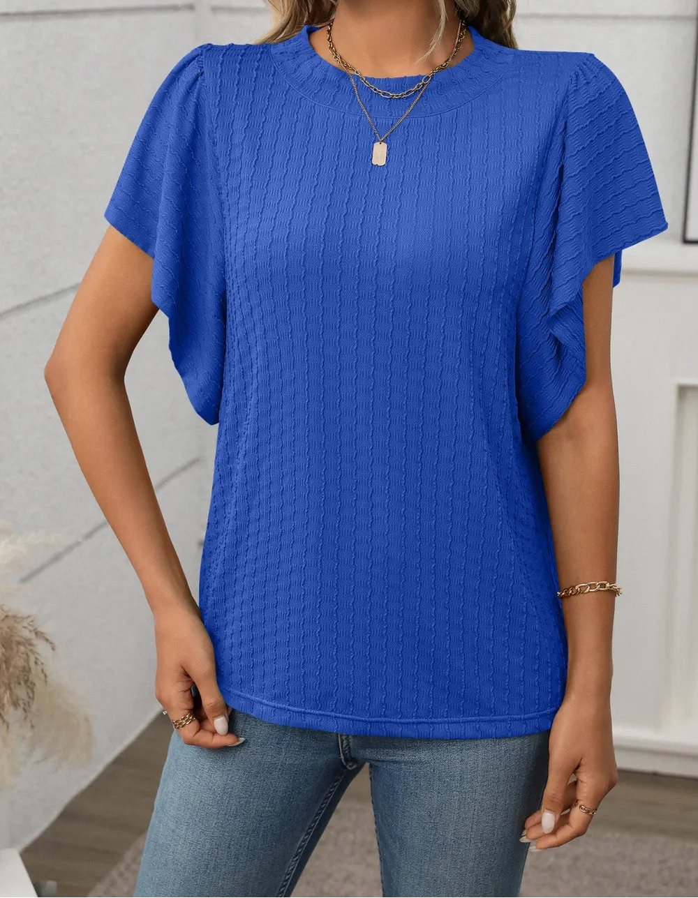 Marigold Collections Australia round neck flutter sleeve top in soft fabric, displayed on a hanger against a neutral background.