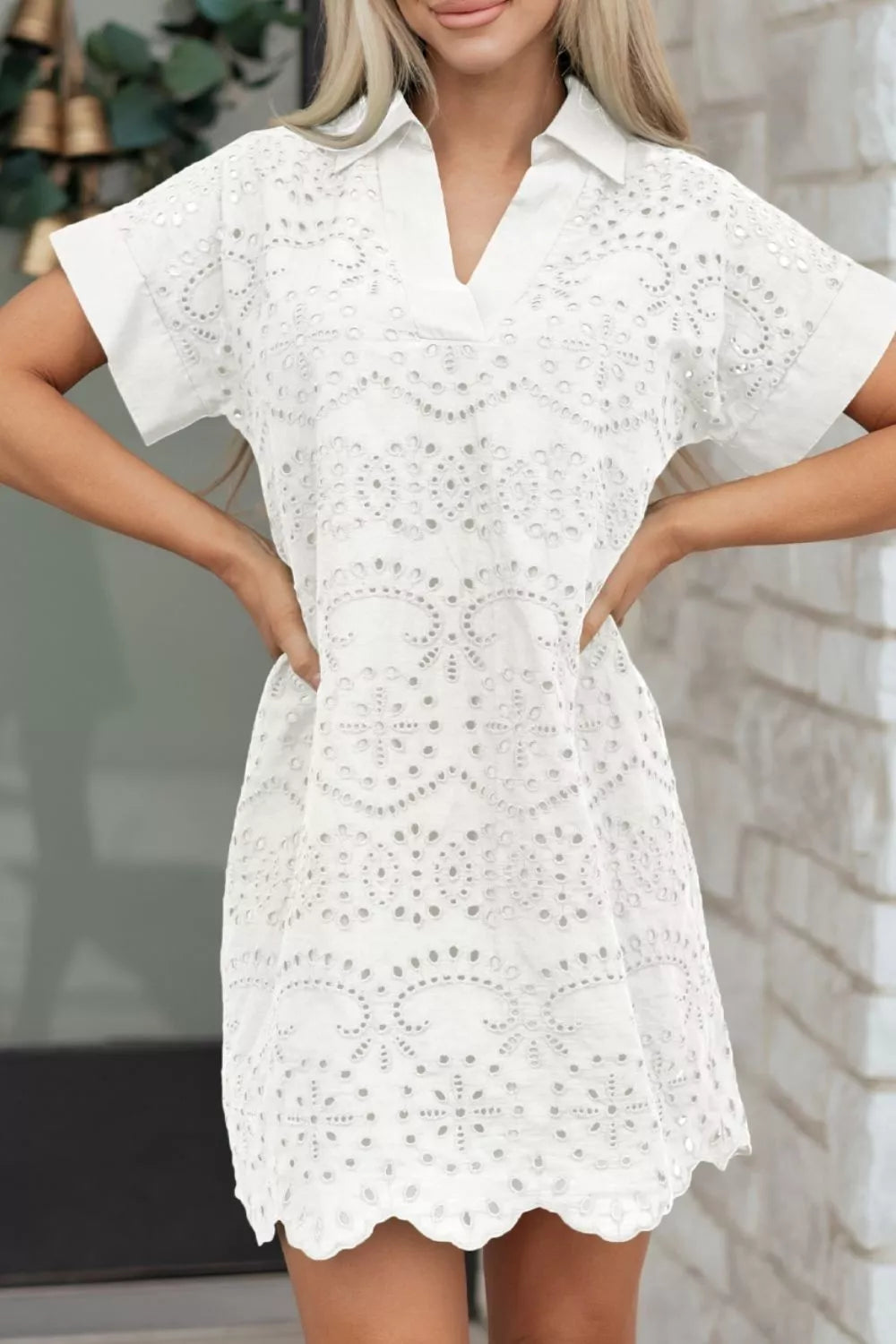 White eyelet collared mini dress by Marigold Collections Australia, featuring a feminine design and button details.