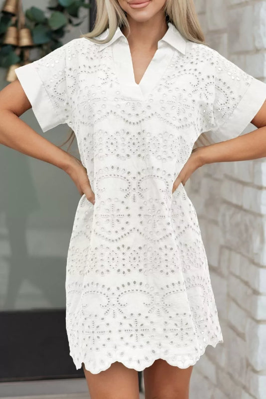 White eyelet collared mini dress by Marigold Collections Australia, featuring a feminine design and button details.