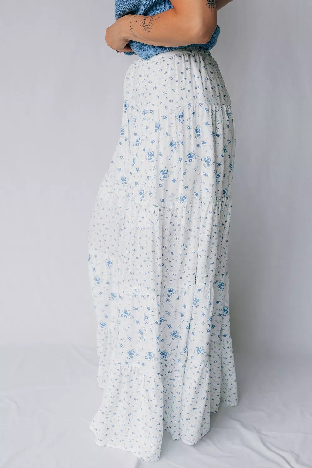 Blue floral tiered maxi skirt by Marigold Collections Australia, flowing fabric with multiple ruffled layers.