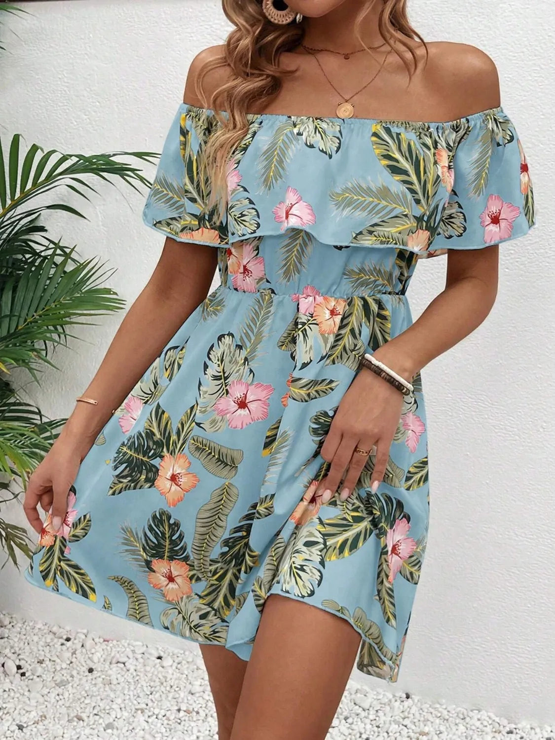 Tropical print off-shoulder mini dress by Marigold Collections Australia, lightweight fabric with vibrant floral pattern.