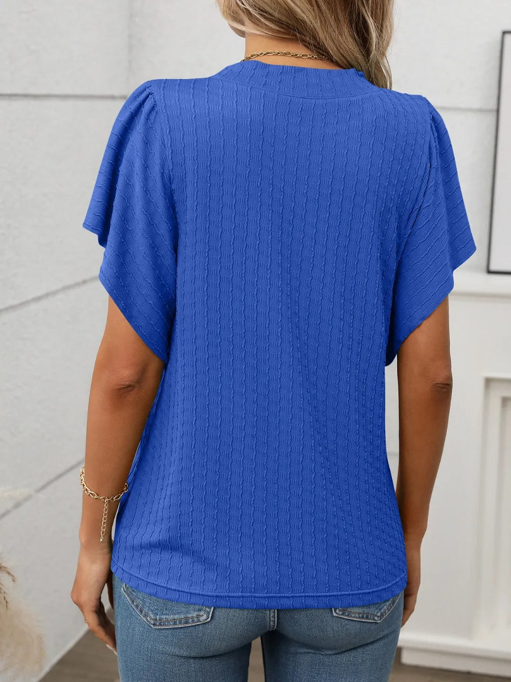Marigold Collections Australia round neck flutter sleeve top with a relaxed fit, lightweight fabric, and feminine design.