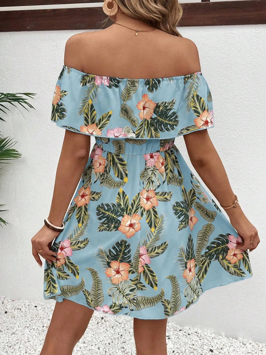 Tropical print off-shoulder mini dress by Marigold Collections Australia, featuring vibrant floral patterns and lightweight fabric.