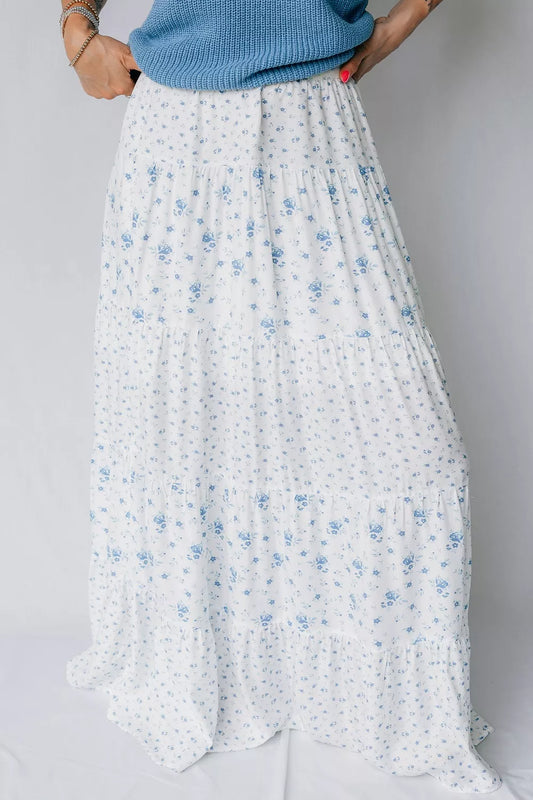 Blue floral tiered maxi skirt by Marigold Collections Australia, featuring flowing fabric and a layered design.