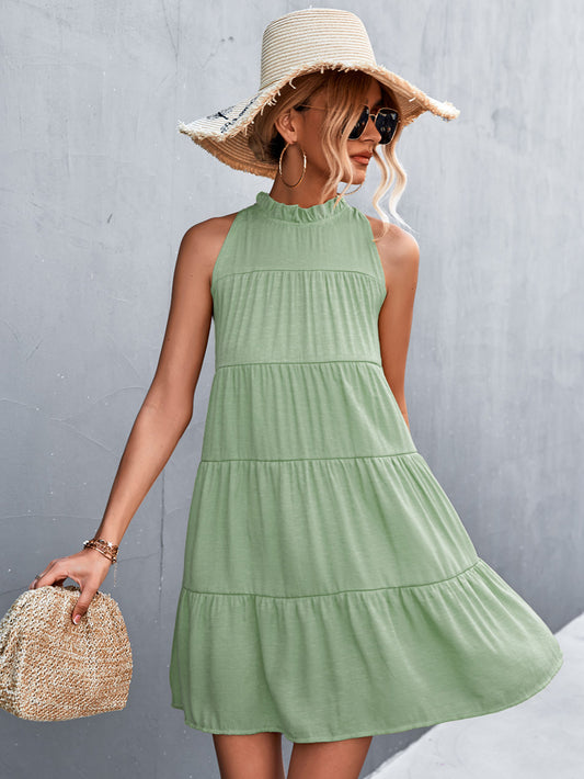 Light green sleeveless tiered dress with a high neckline and back tie from Marigold Collections Australia.