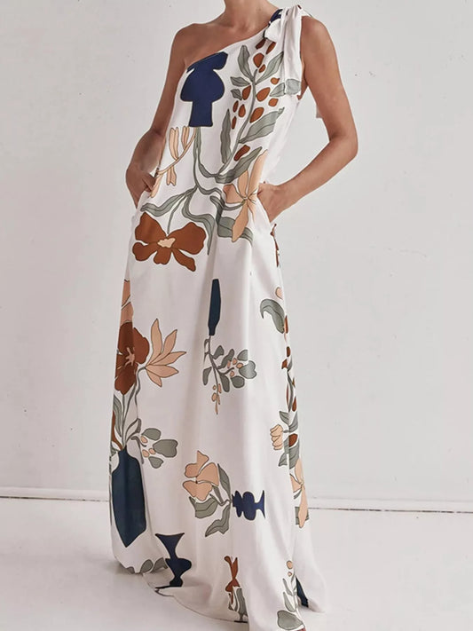 Tall modern floral print one-shoulder maxi dress from Marigold Collections Australia, flowing fabric with vibrant floral design.