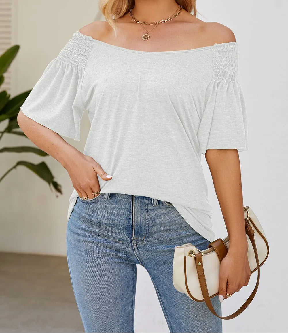 White smocked shoulder flutter sleeve top from Marigold Collections Australia, featuring airy, stylish design and lightweight fabric.