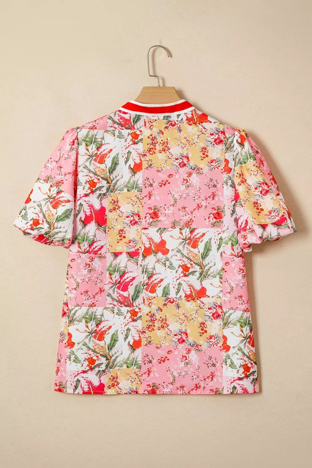 Floral blouse with contrast collar, V-neck, short sleeves, from Marigold Collections Australia, featuring a colorful floral pattern.
