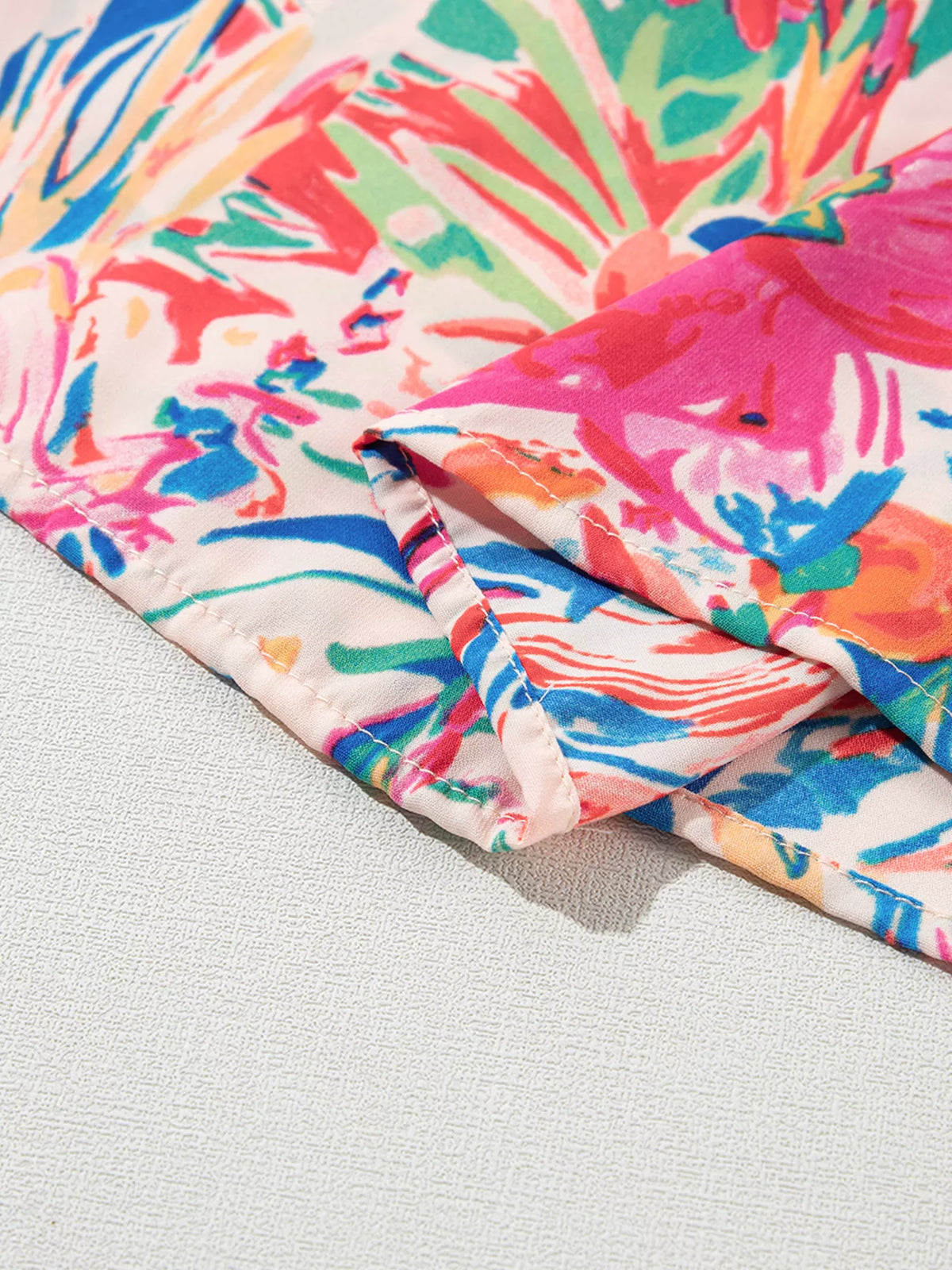 Multicolour floral ruffled sleeve V-neck summer blouse by Marigold Collections Australia, featuring vibrant floral patterns and elegant design.