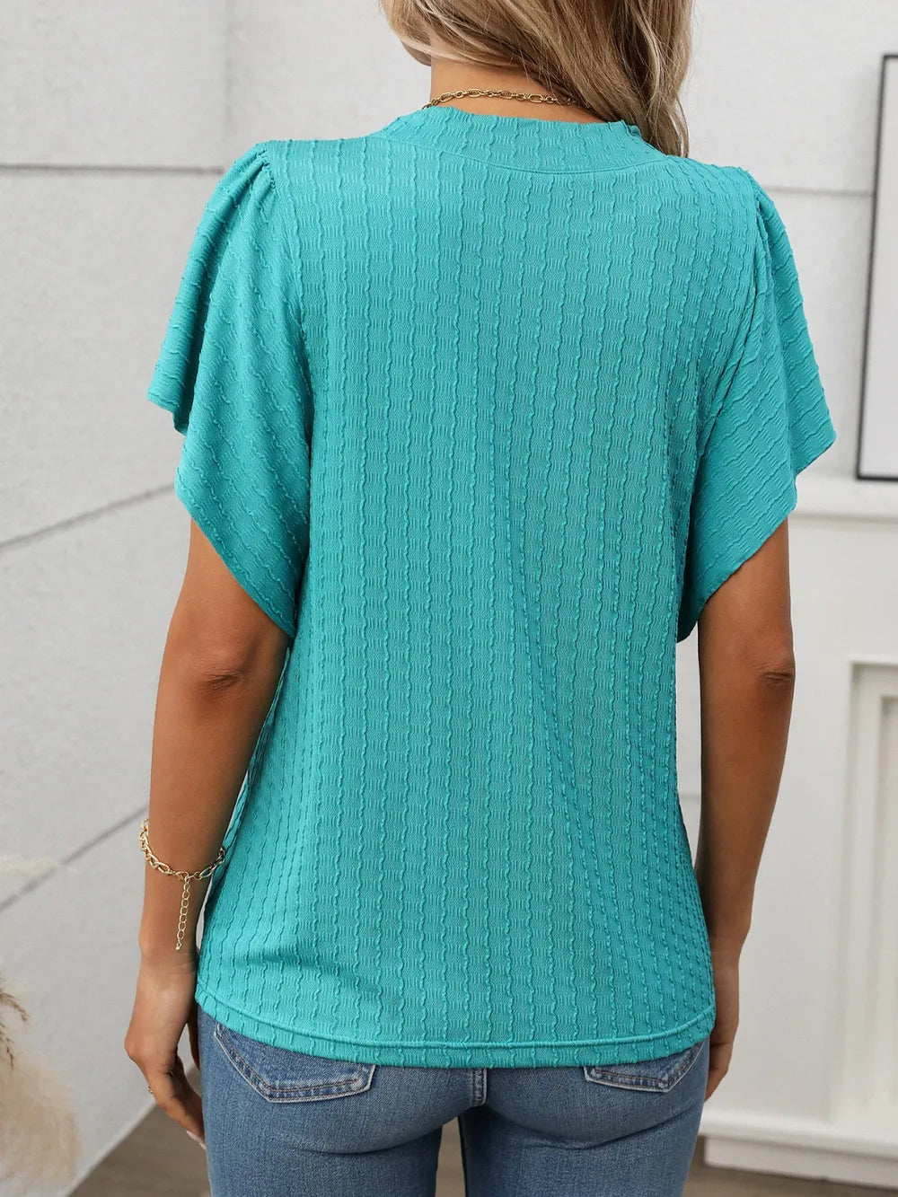 Marigold Collections Australia round neck flutter sleeve top in soft fabric, shown on a model with a casual, elegant style.