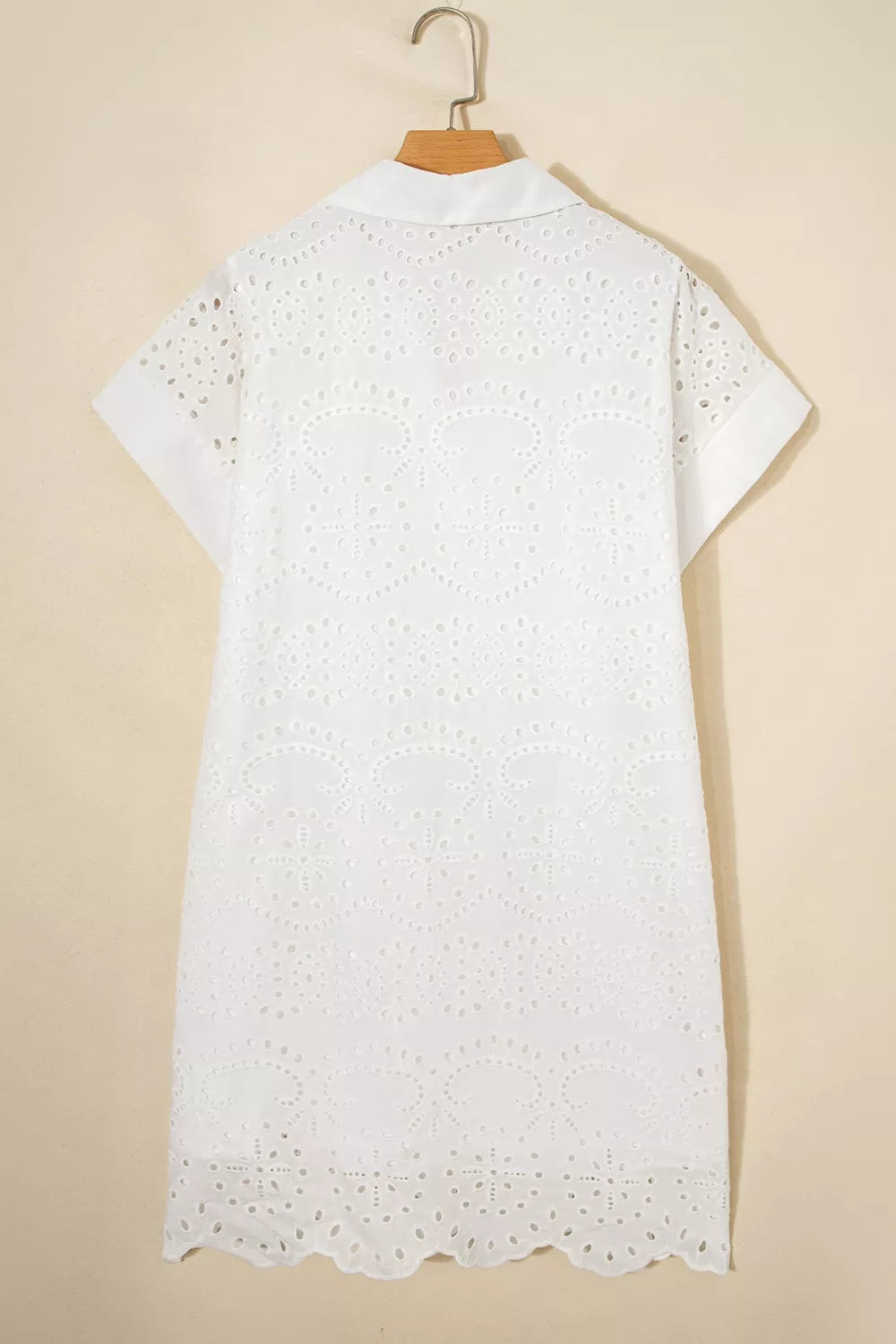 White eyelet collared mini dress by Marigold Collections Australia, featuring a feminine design with a fitted silhouette and button details.