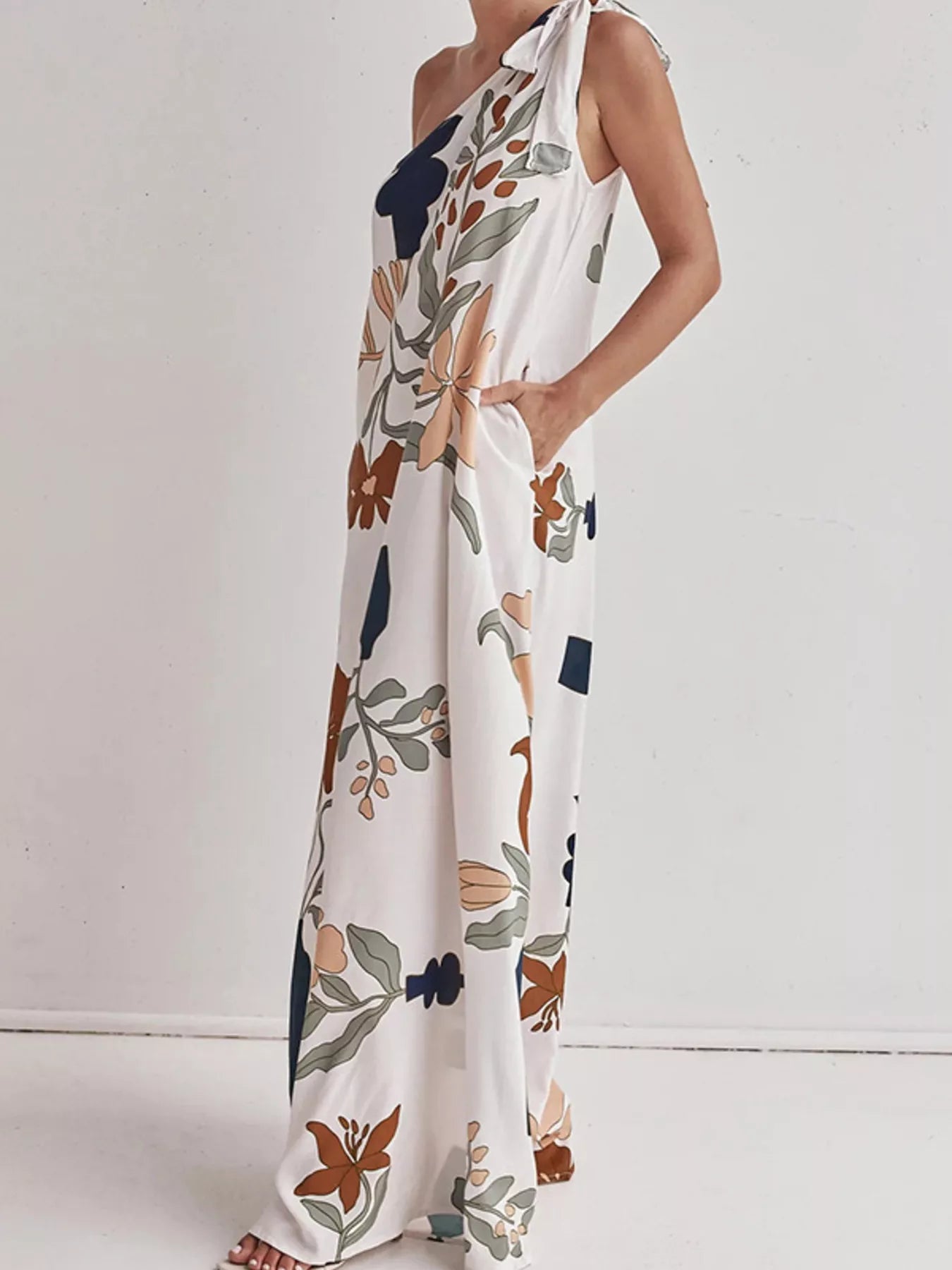 Tall modern floral print one-shoulder maxi dress by Marigold Collections Australia, flowing fabric with vibrant floral pattern.