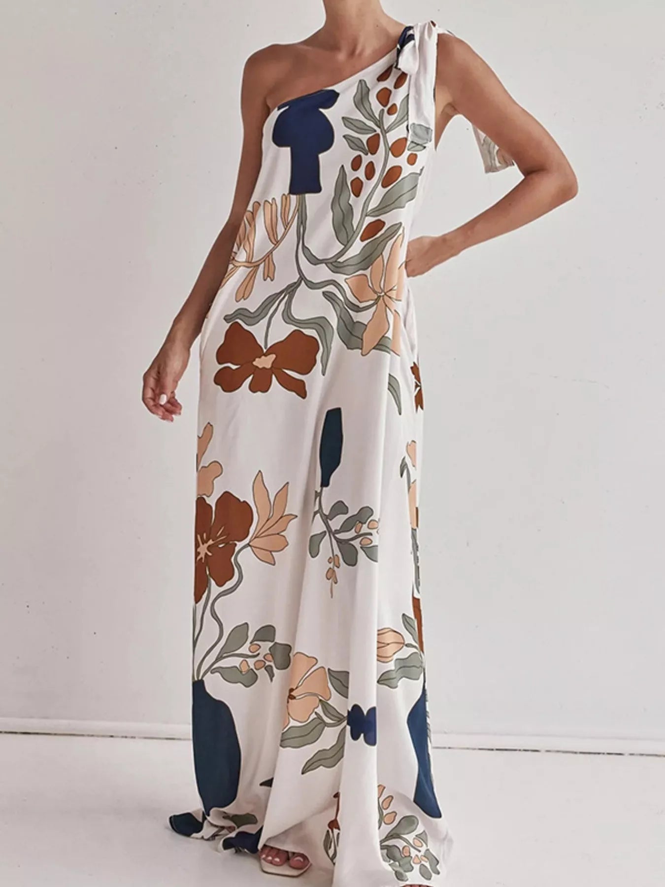 Tall modern floral print one-shoulder maxi dress by Marigold Collections Australia, featuring a flowing silhouette and vibrant floral pattern.