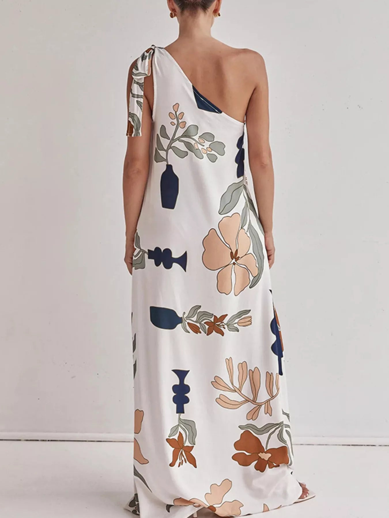 Tall modern floral print one-shoulder maxi dress by Marigold Collections Australia, featuring a flowing design and vibrant floral pattern.