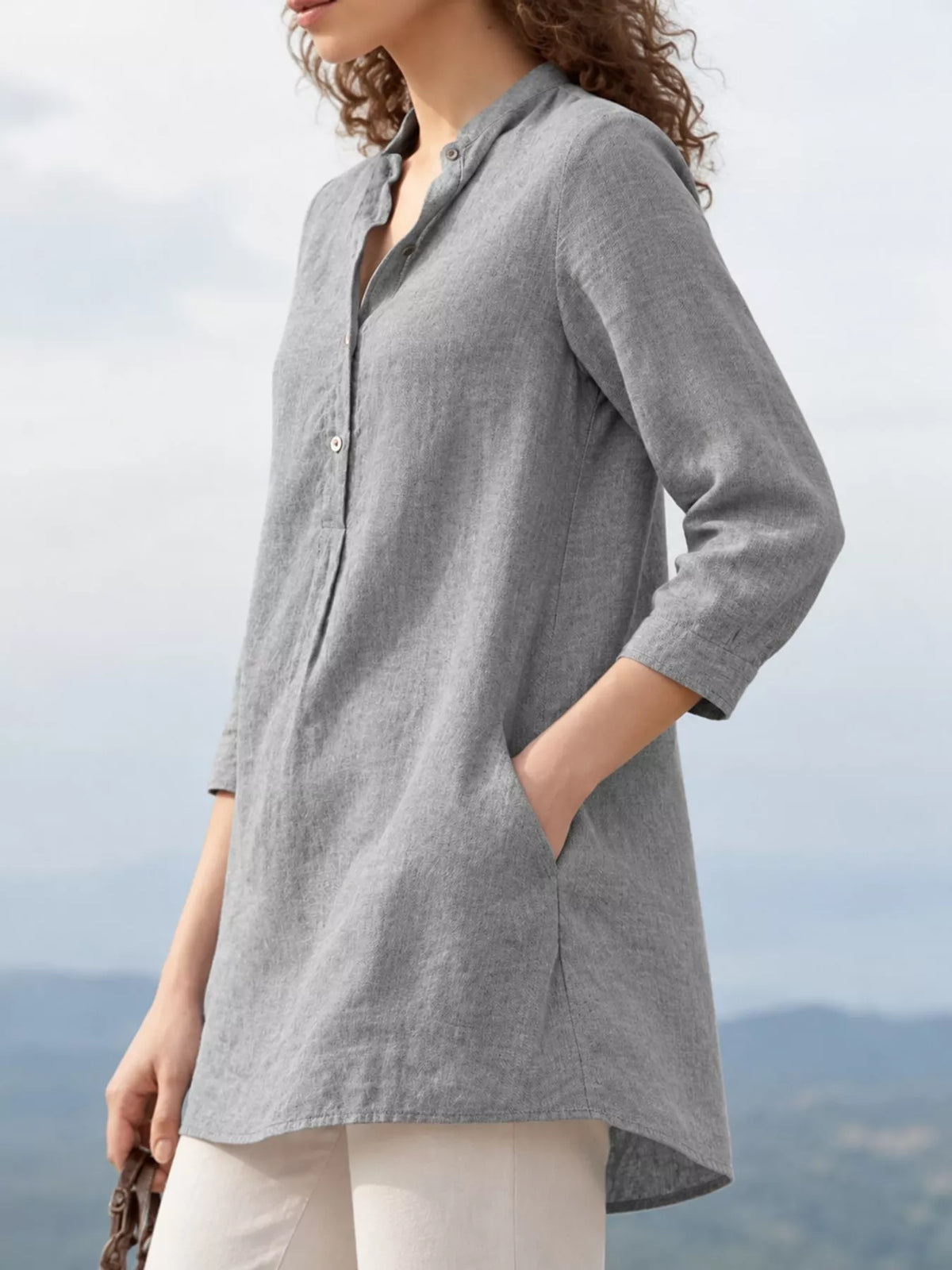 Marigold Collections Australia half-button pocketed 3/4 sleeve blouse with a relaxed fit, displayed on a hanger.