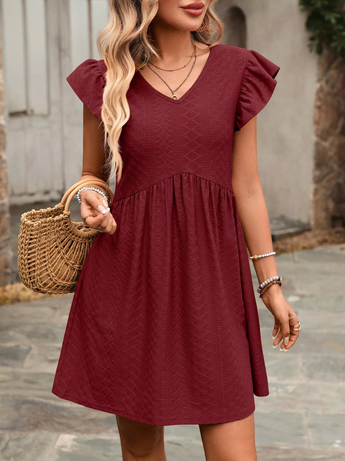 Marigold Collections Australia ruffle sleeve V-neck A-line mini dress with floral pattern and flowy fabric.