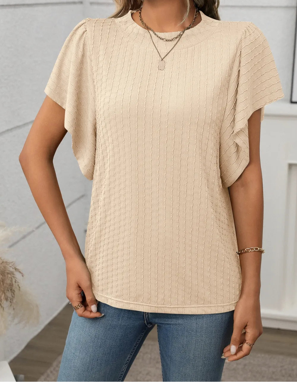 Marigold Collections Australia round neck flutter sleeve top in soft fabric, shown in a stylish blouse with flutter sleeves.