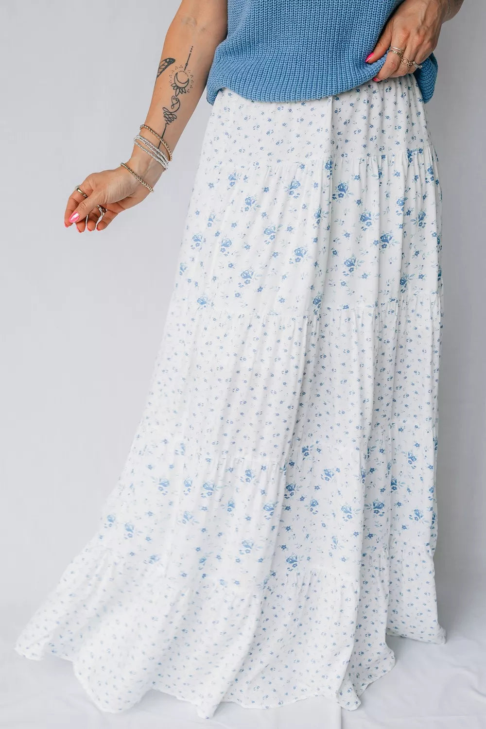 Blue floral tiered maxi skirt from Marigold Collections Australia featuring flowing fabric and layered design.