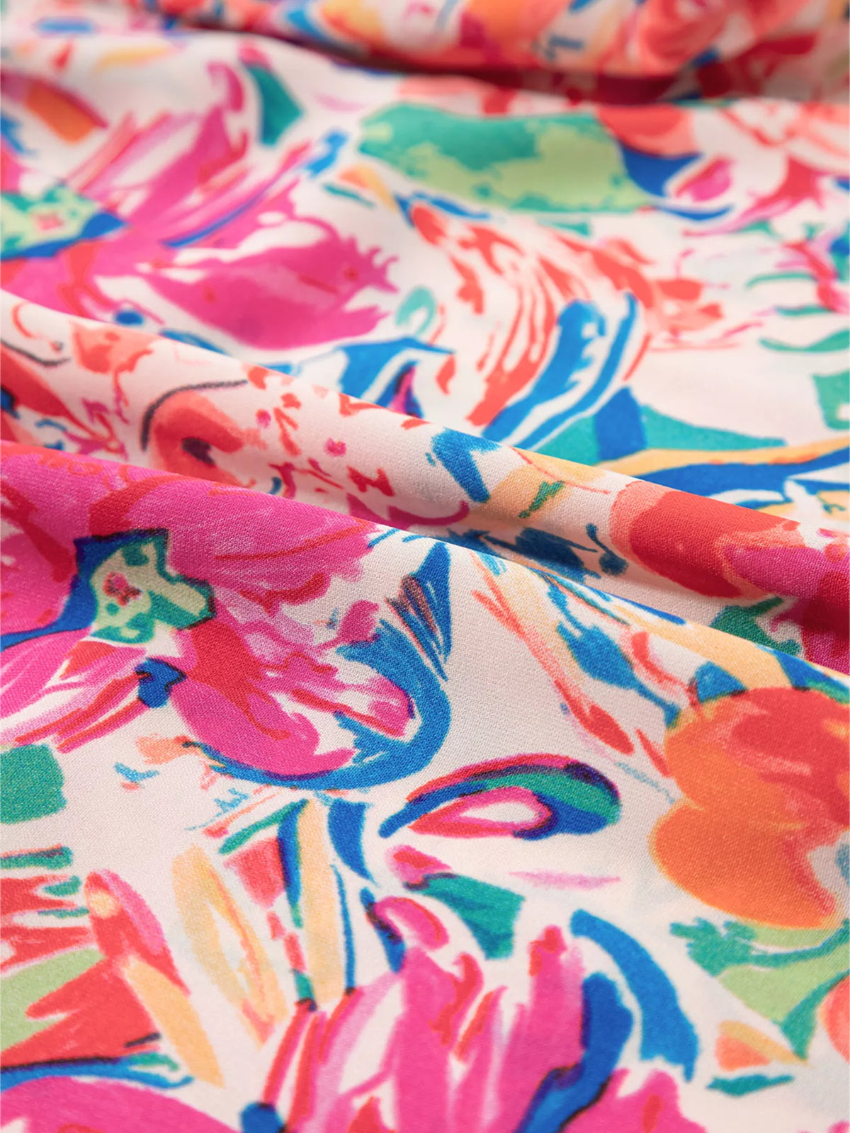 Multicolour floral ruffled sleeve V-neck summer blouse from Marigold Collections Australia, featuring vibrant print and lightweight fabric.