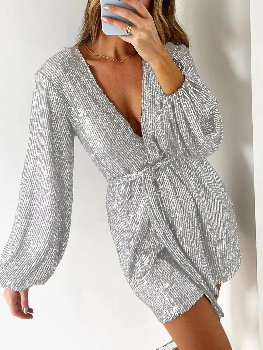 Dark green sequin long sleeve romper by Marigold Collections Australia, featuring a surplice neckline and tie waist for evening wear.
