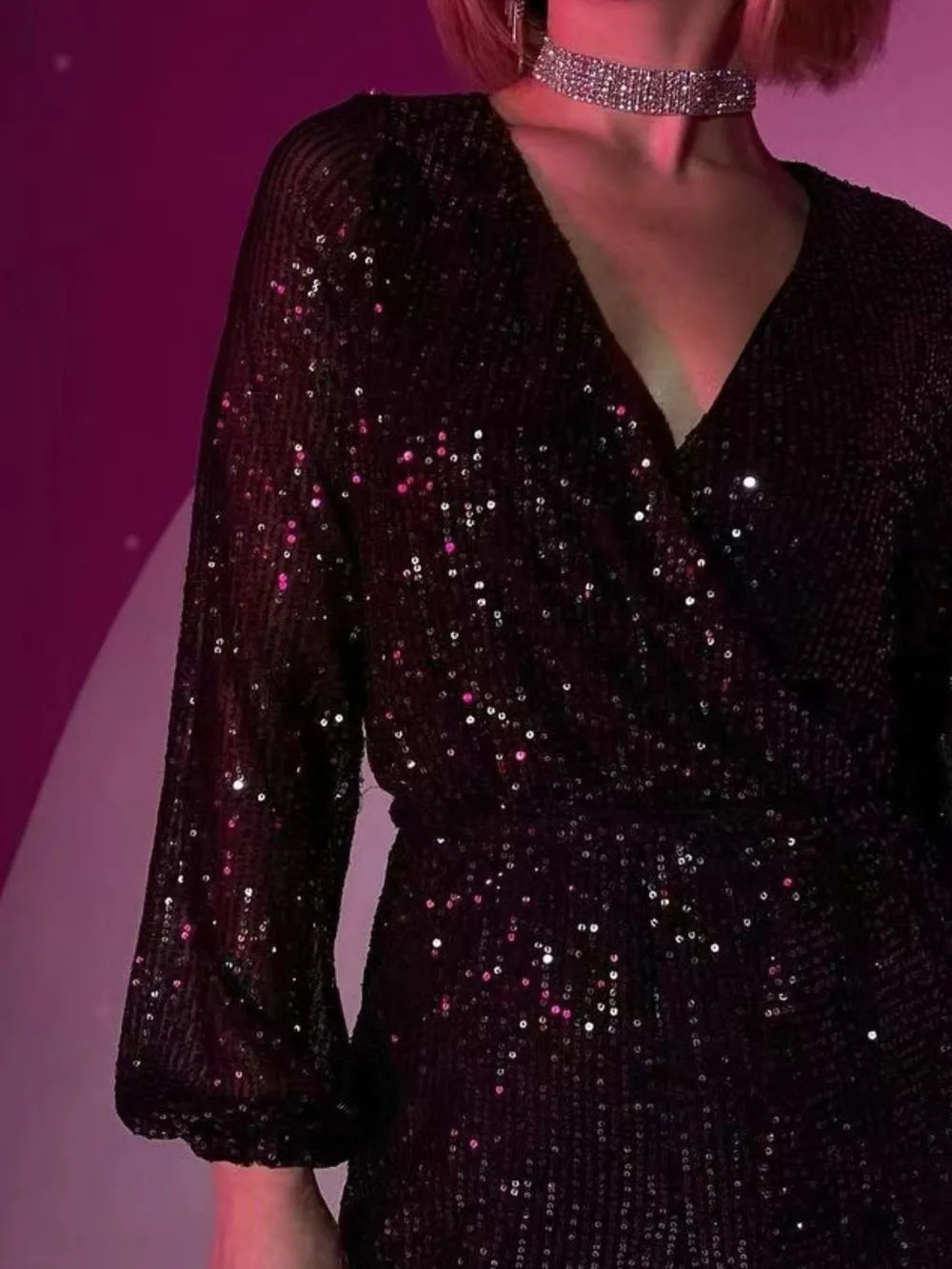 Dark green sequin long sleeve romper by Marigold Collections Australia featuring surplice tie waist and elegant evening dress style.