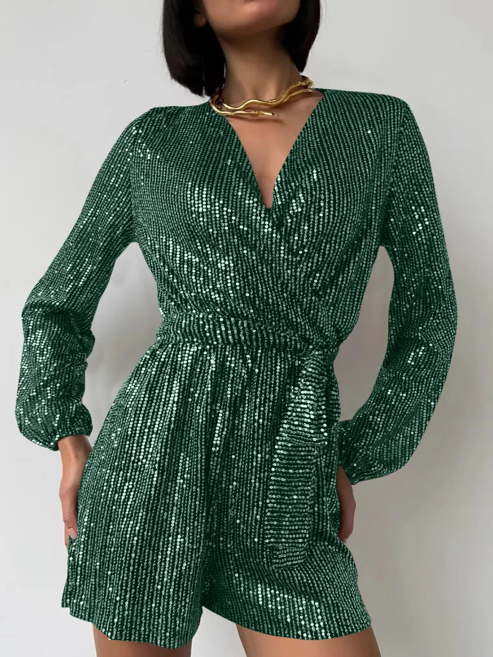 Dark green sequin long sleeve romper by Marigold Collections Australia, featuring a surplice neckline and tie waist for formal occasions.
