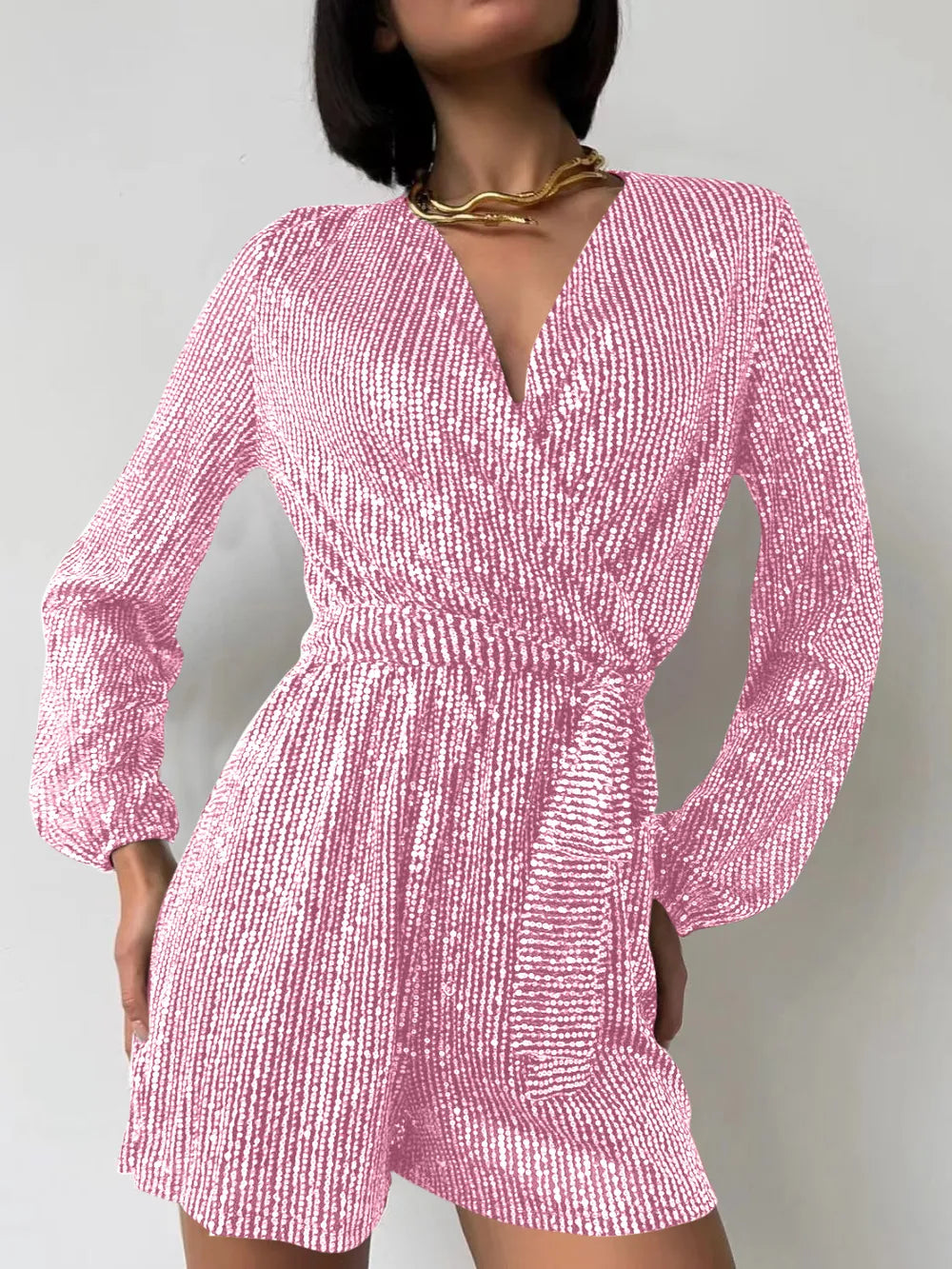 Dark green sequin long sleeve romper by Marigold Collections Australia, featuring a surplice tie waist and elegant evening dress style.