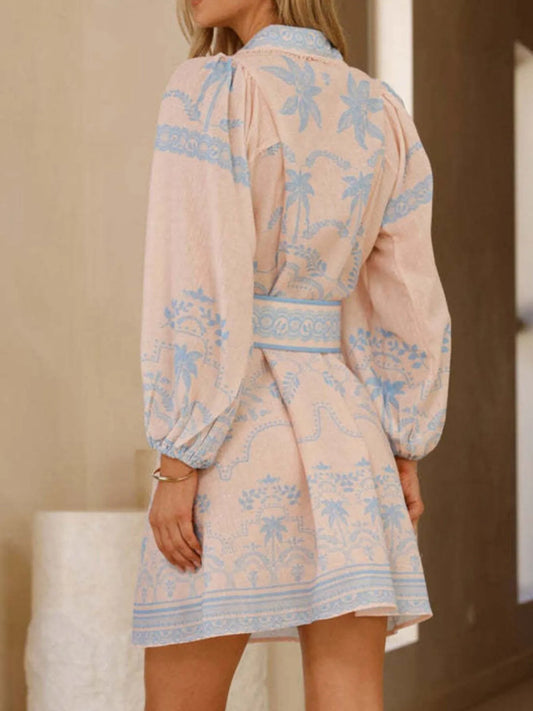 Blue palm print belted shirt dress by Marigold Collections Australia, shown on a woman, featuring a classic shirt style with a waist belt.