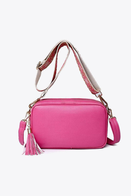 Pink minimalist tassel crossbody bag by Marigold Collections Australia, featuring a sleek design and adjustable strap.